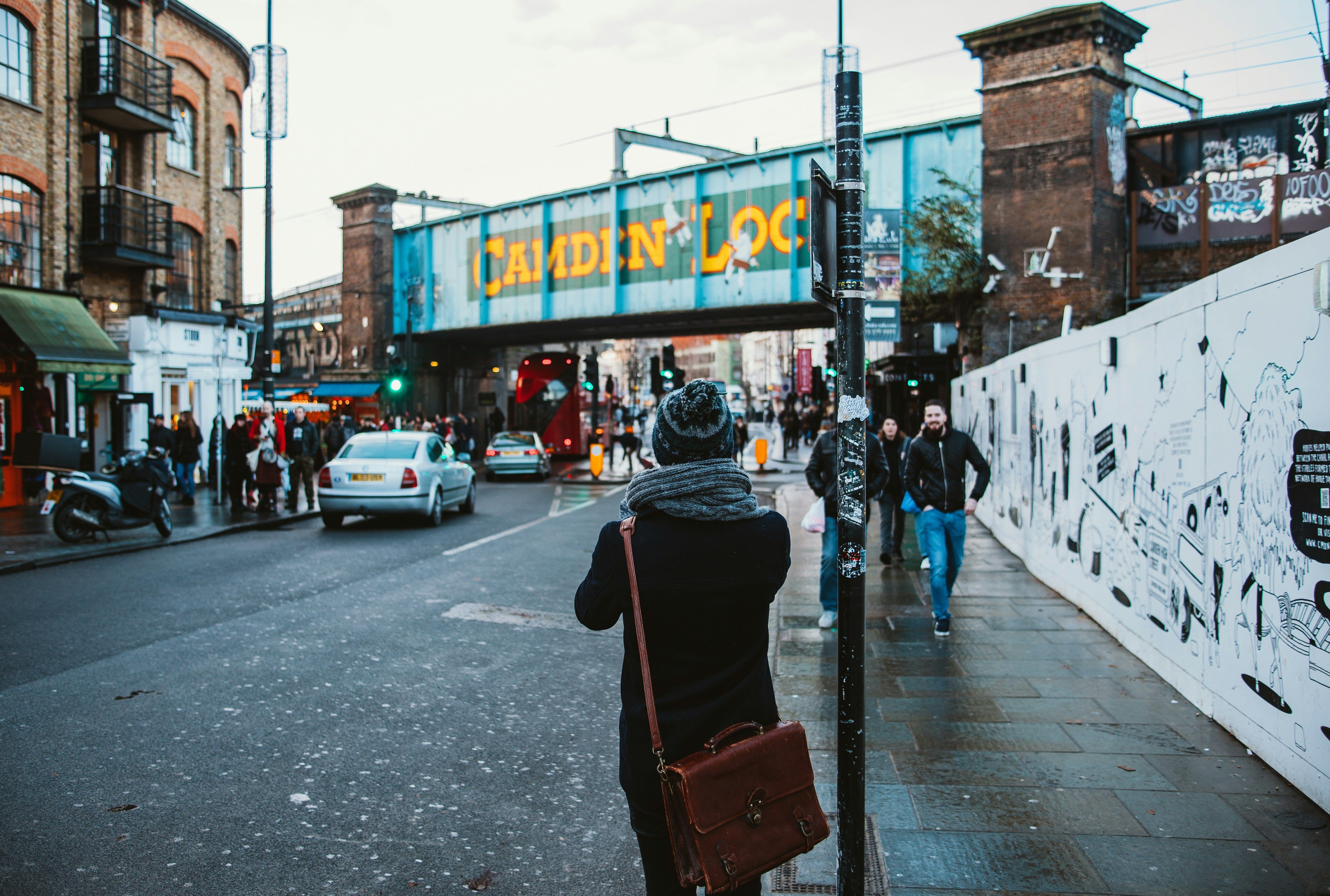 An image of a woman in London looking at traffic lights